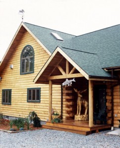 entryway to lo ghome with carved Moose on side porch, log home roof, Timberhaven Log Homes, log homes, log cabin homes, log cabins, post and beam homes, timberframe homes, timber frame homes, laminated logs, engineered logs, floor plan designs, kiln dried logs, Flury Builders, Joe Walsh, Timberhaven local reps, log homes in Massachusetts, log homes in Rhode Island, MA, RI, log home builders