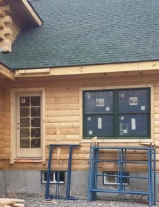 windows and doors being installed in log home, windows and doors, Timberhaven Log Homes, log homes, log cabin homes, log cabins, post and beam homes, timberframe homes, timber frame homes, laminated logs, engineered logs, floor plan designs, kiln dried logs, Flury Builders, Joe Walsh, Timberhaven local reps, log homes in Massachusetts, log homes in Rhode Island, MA, RI, log home builders