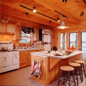 kitchen in log home with track lighting and eat-in bar, electrical wiring in a log home, Timberhaven Log Homes, log homes, log cabin homes, log cabins, post and beam homes, timberframe homes, timber frame homes, laminated logs, engineered logs, floor plan designs, kiln dried logs, Flury Builders, Joe Walsh, Timberhaven local reps, log homes in Massachusetts, log homes in Rhode Island, MA, RI, log home builders