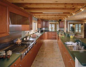 galley kitchen with exposed round heavy timbers, log home flooring, Timberhaven Log Homes, log homes, log cabin homes, log cabins, post and beam homes, timberframe homes, timber frame homes, laminated logs, engineered logs, floor plan designs, kiln dried logs, Flury Builders, Joe Walsh, Timberhaven local reps, log homes in Massachusetts, log homes in Rhode Island, MA, RI, log home builders