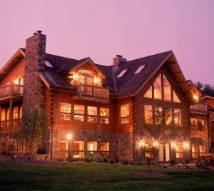 large log home at dusk with lots of lights on, electrical wiring in a log home, Timberhaven Log Homes, log homes, log cabin homes, log cabins, post and beam homes, timberframe homes, timber frame homes, laminated logs, engineered logs, floor plan designs, kiln dried logs, Flury Builders, Joe Walsh, Timberhaven local reps, log homes in Massachusetts, log homes in Rhode Island, MA, RI, log home builders