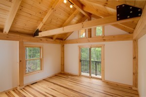 bedroom of post and beam home with cathedral ceiling and private balcony, log and timber homes, Timberhaven Log Homes, log homes, log cabin homes, log cabins, post and beam homes, timberframe homes, timber frame homes, laminated logs, engineered logs, floor plan designs, kiln dried logs, Timberhaven local reps, log homes in Pennsylvania, log homes in PA, PA homes, log home builder