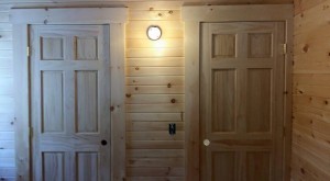 two white pine interior doors side by side in log home, Name-brand components, Timberhaven Log Homes, Timberhaven Log and Timber Homes, log homes, log cabin homes, log cabins, post and beam homes, timberframe homes, timber frame homes, laminated logs, engineered logs, floor plan designs, kiln dried logs, Timberhaven local reps, log homes in PA, log home builders, kiln dried, interior finishes
