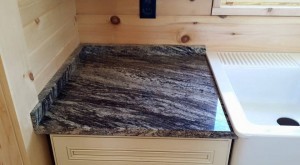 rocky mountain granite countertop beside sink in log home, Log home kitchen, Timberhaven Log Homes, log homes, log cabin homes, log cabins, post and beam homes, timberframe homes, timber frame homes, laminated logs, engineered logs, floor plan designs, kiln dried logs, Timberhaven local reps, log homes in PA, log home builders