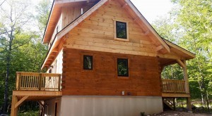 log home being stained, q8 log oil, log homes, log cabin homes, log cabins, post and beam homes, timberframe homes, timber frame homes, laminated logs, engineered logs, floor plan designs, kiln dried logs, Timberhaven local reps, log homes in Pennsylvania, log homes in PA, Timberhaven Log Homes, Timberhaven Log & Timber Homes