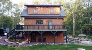 rear of log home with finished decking, exterior finishes, Log home kitchens, Timberhaven Log Homes, log homes, log cabin homes, log cabins, post and beam homes, timberframe homes, timber frame homes, laminated logs, engineered logs, floor plan designs, kiln dried logs, Timberhaven local reps, log homes in PA, log home builders