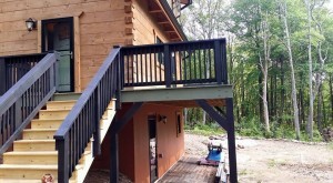 black railing on deck and stairs, exterior finishes, Log home kitchens, Timberhaven Log Homes, log homes, log cabin homes, log cabins, post and beam homes, timberframe homes, timber frame homes, laminated logs, engineered logs, floor plan designs, kiln dried logs, Timberhaven local reps, log homes in PA, log home builders