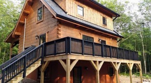 rear of log home with stain on deck railing, exterior finishes, Log home kitchens, Timberhaven Log Homes, log homes, log cabin homes, log cabins, post and beam homes, timberframe homes, timber frame homes, laminated logs, engineered logs, floor plan designs, kiln dried logs, Timberhaven local reps, log homes in PA, log home builders