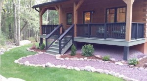 finished front porch of log home, exterior finishes, Log home kitchens, Timberhaven Log Homes, log homes, log cabin homes, log cabins, post and beam homes, timberframe homes, timber frame homes, laminated logs, engineered logs, floor plan designs, kiln dried logs, Timberhaven local reps, log homes in PA, log home builders