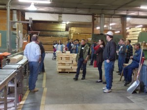 group watching expert cut logs during construction workshop, log home planning seminar, Log home kitchens, Timberhaven Log Homes, log homes, log cabin homes, log cabins, post and beam homes, timberframe homes, timber frame homes, laminated logs, engineered logs, floor plan designs, kiln dried logs, Timberhaven local reps, log homes in PA, log home builders