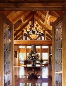 door opening to luxurious log homes, wrought iron table and ballisters, grand chandelier in log home, ultimate home, ultimate log home, Log home kitchens, Timberhaven Log Homes, log homes, log cabin homes, log cabins, post and beam homes, timberframe homes, timber frame homes, laminated logs, engineered logs, floor plan designs, kiln dried logs, Timberhaven local reps, log homes in PA, log home builders