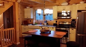 galley kitchen in finished log home, white kitchen cabinetry, custom kitchen cabinets, ultimate home, ultimate log home, Log home kitchens, Timberhaven Log Homes, log homes, log cabin homes, log cabins, post and beam homes, timberframe homes, timber frame homes, laminated logs, engineered logs, floor plan designs, kiln dried logs, Timberhaven local reps, log homes in PA, log home builders