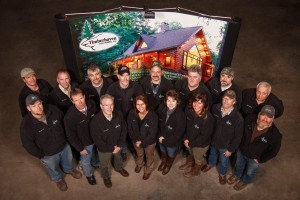 group of employees standing by sign, merry christmas, log homes, log cabin homes, log cabins, post and beam homes, timberframe homes, timber frame homes, laminated logs, engineered logs, floor plan designs, kiln dried logs, Timberhaven local reps, log homes in Pennsylvania, log homes in PA, Timberhaven Log Homes, Timberhaven Log & Timber Homes