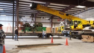 planer being lifted off truck, new location, Timberhaven Log Homes, Timberhaven Log & Timber Homes, log homes, log cabin homes, log cabins, post and beam homes, timberframe homes, timber frame homes, laminated logs, engineered logs, floor plan designs, kiln dried logs, Timberhaven local reps, log homes in Pennsylvania, PA