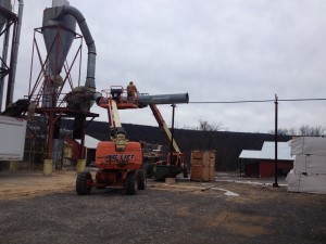 a man removing metal conduit, We are moving, Timberhaven Log Homes, Timberhaven Log & Timber Homes, log homes, log cabin homes, log cabins, post and beam homes, timberframe homes, timber frame homes, laminated logs, engineered logs, floor plan designs, kiln dried logs, Timberhaven local reps, log homes in Pennsylvania, PA