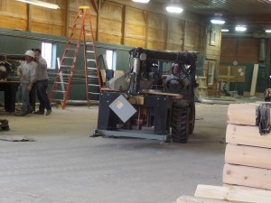 forklift carrying radial arm saw, Timberhaven relocation, log homes, log cabin homes, log cabins, post and beam homes, timberframe homes, timber frame homes, laminated logs, engineered logs, floor plan designs, kiln dried logs, Timberhaven local reps, log homes in Pennsylvania, log homes in PA, Timberhaven Log Homes, Timberhaven Log & Timber Homes