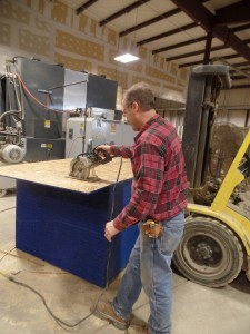 guy using circular saw on plywood, making great progress, log homes, log cabin homes, log cabins, post and beam homes, timberframe homes, timber frame homes, laminated logs, engineered logs, floor plan designs, kiln dried logs, Timberhaven local reps, log homes in Pennsylvania, log homes in PA, Timberhaven Log Homes, Timberhaven Log & Timber Homes