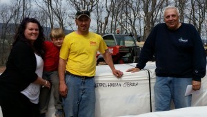 family and Timberhaven rep posing by log pack on delivery day, delivery day, log homes, log cabin homes, log cabins, post and beam homes, timberframe homes, timber frame homes, laminated logs, engineered logs, floor plan designs, kiln dried logs, Timberhaven local reps, log homes in Pennsylvania, log homes in PA, Timberhaven Log Homes, Timberhaven Log & Timber Homes