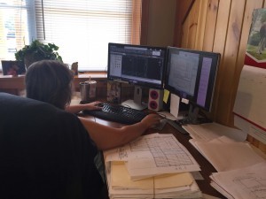 woman sitting at desk working on AutoCAD, wendi zimmerman-roush, log homes, log cabin homes, log cabins, post and beam homes, timberframe homes, timber frame homes, laminated logs, engineered logs, floor plan designs, kiln dried logs, Timberhaven local reps, log homes in Pennsylvania, log homes in PA, Timberhaven Log Homes, Timberhaven Log & Timber Homes