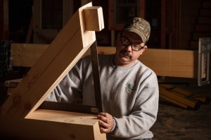 person checking dimenions of log joints, handcrafter talks timber frame, log homes, log cabin homes, log cabins, post and beam homes, timberframe homes, timber frame homes, laminated logs, engineered logs, floor plan designs, kiln dried logs, Timberhaven local reps, log homes in Pennsylvania, log homes in PA, Timberhaven Log Homes, Timberhaven Log & Timber Homes