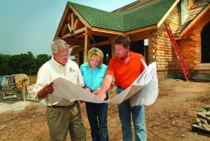 couple working with builder at construction site holding set of plans, find right builder, log homes, log cabin homes, log cabins, post and beam homes, timberframe homes, timber frame homes, laminated logs, engineered logs, floor plan designs, kiln dried logs, Timberhaven local reps, log homes in Pennsylvania, log homes in PA, Timberhaven Log Homes, Timberhaven Log & Timber Homes