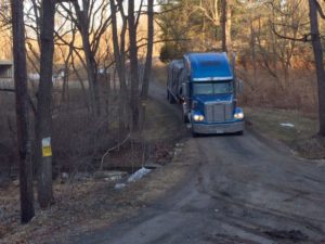 tractor trailer truck driving down driveway, log home delivery day, log homes, log cabin homes, log cabins, post and beam homes, timberframe homes, timber frame homes, laminated logs, engineered logs, floor plan designs, kiln dried logs, Timberhaven local reps, log homes in Pennsylvania, log homes in PA, Timberhaven Log Homes, Timberhaven Log & Timber Homes