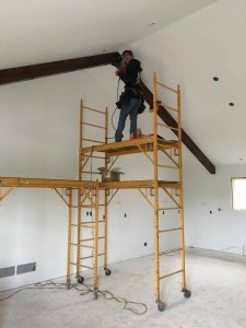 one worker installing beam on ceiling, Bitter sweet dream home, log homes, log cabin homes, log cabins, post and beam homes, timberframe homes, timber frame homes, laminated logs, engineered logs, floor plan designs, kiln dried logs, Timberhaven local reps, log homes in Pennsylvania, log homes in PA, Timberhaven Log Homes, Timberhaven Log & Timber Homes