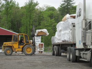 forklift loading log packs onto truck, log home delivery day, log homes, log cabin homes, log cabins, post and beam homes, timberframe homes, timber frame homes, laminated logs, engineered logs, floor plan designs, kiln dried logs, Timberhaven local reps, log homes in Pennsylvania, log homes in PA, Timberhaven Log Homes, Timberhaven Log & Timber Homes