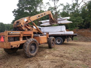 LULL unloading packs of logs, log home delivery day, log homes, log cabin homes, log cabins, post and beam homes, timberframe homes, timber frame homes, laminated logs, engineered logs, floor plan designs, kiln dried logs, Timberhaven local reps, log homes in Pennsylvania, log homes in PA, Timberhaven Log Homes, Timberhaven Log & Timber Homes