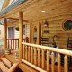 Log Home Porch with Rustic Rail Treatment Illustrates the Use of Natural Building Components in Log Home Construction