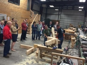 group looking at timber frame joinery, laminated logs, engineered logs, lamination process, log homes, timber frame homes, Timberhaven