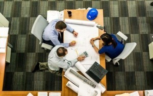 three folks sitting at a desk, researching, log home plans, researching log home companies, talking with log home companies, log homes, log cabins, log cabin homes, timber frame homes, timber homes, Timberhaven Log & Timber Homes, log home manufacturers