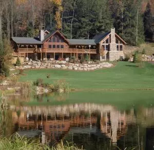 very large log home by a pond, Log Home Addition to Existing Log Home, log home additions, timber frame home additions, Timberhaven, home additions with wood, log homes, Engineered logs