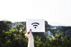 personal holding wifi signal on small sign, smart forever home, log homes, log cabins, timber frame homes, timber homes, smart log homes, smart log cabins, Timberhaven,