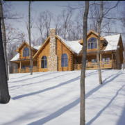 Traditional style log home in the snow.