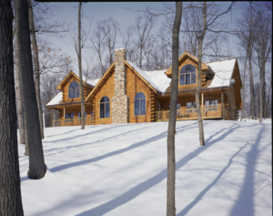 Traditional style log home in the snow.