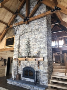 fireplace and King post truss, farmhouse inspired log home, log home, log home living, log home great room, cathedral ceilingTimberhaven, kiln dried