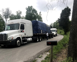 tractor trailer truck parked on road, New Model Log Home Delivery, log home delivery, delivery day, log homes, Timberhaven, local reps, model home in TN