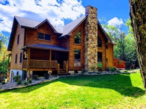 two story log home with windows and fireplace, log home, log cabin, log cabin home, Timberhaven, made to last a lifetime