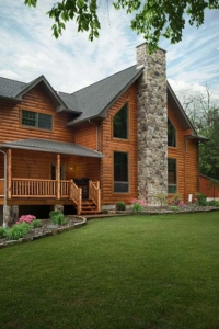 log home with windows and stone chimney, Custom Log Home Features, log homes, log home living, timberhaven, log and timber home living