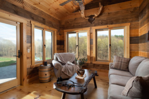 sunroom with wood siding and many windows, timber home living, timber home, timber frame home, timber frame, timberhaven, saratoga