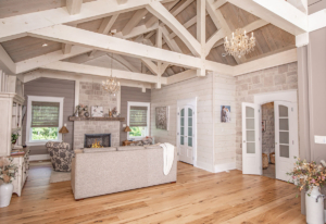 sitting area with fireplace and soaring timbers, timber frame home, timber home, hybrid home, award winning, timber frame pavilion, timberhaven