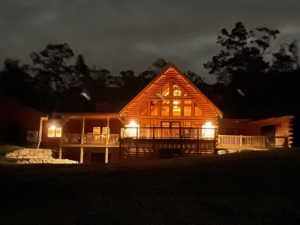 log home exterior glowing in the dark, log home living, log home, Timberhaven, kiln dried, white pine