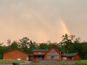 log home exterior with rainbow, log home living, log home, Timberhaven, kiln dried, white pine