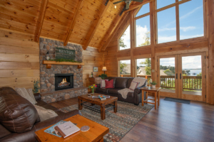 great room with fireplace in log home, wall of glass in a log home, Timberhaven, log homes, magazine article, Lost & Found, Lewis Log Home